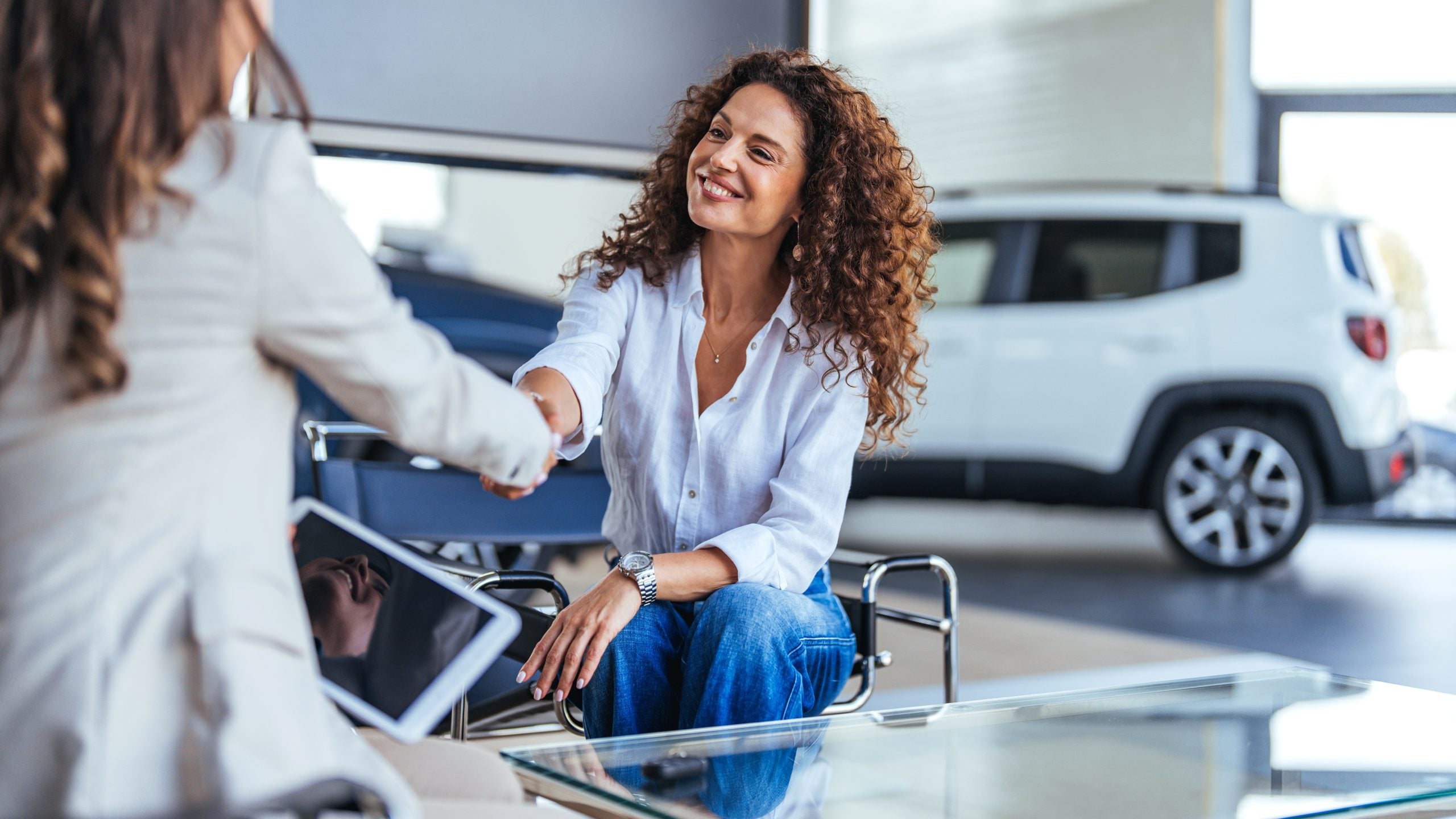 Smiling woman finalizing deal at her local Sisbarro dealership