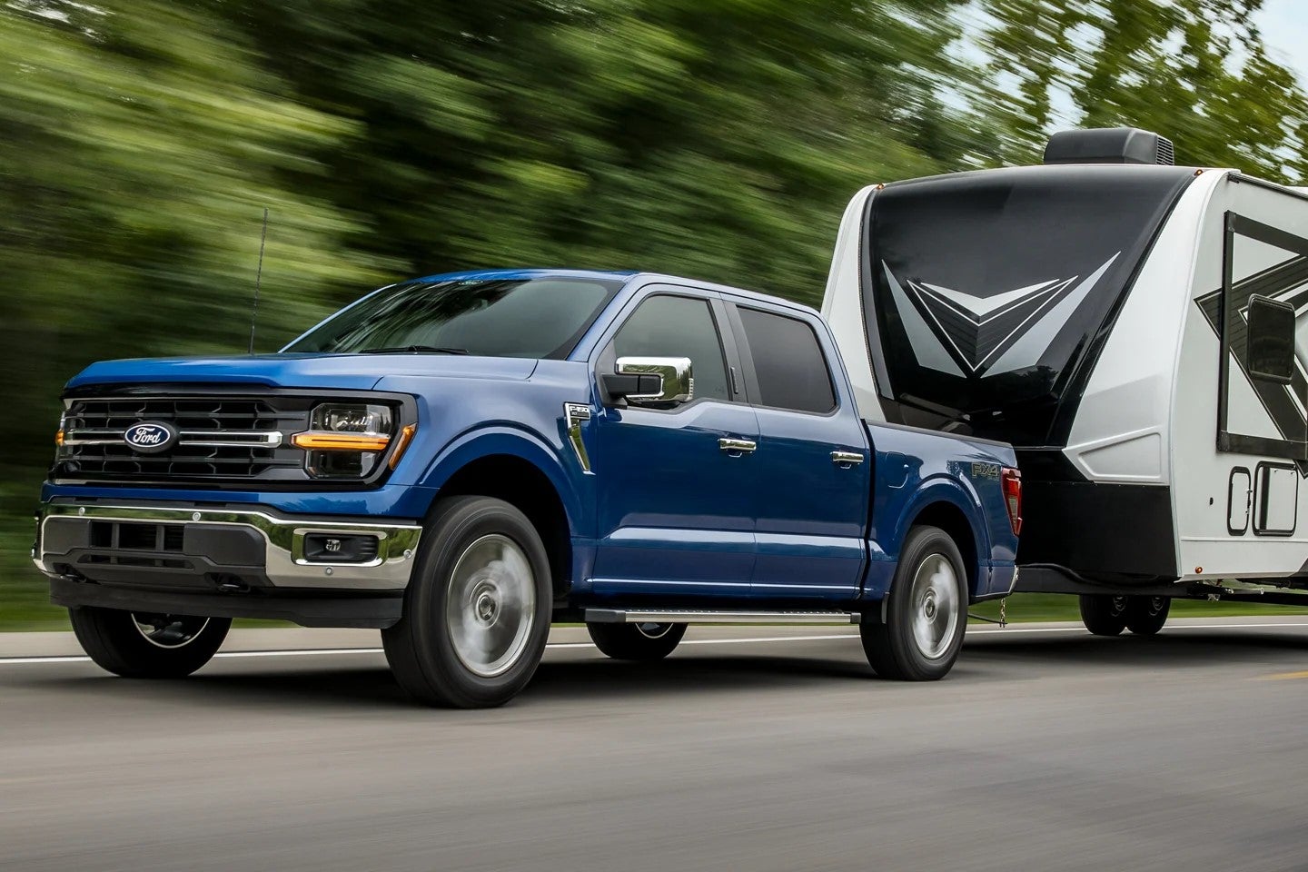 Blue Ford F-150 pulling a trailer 