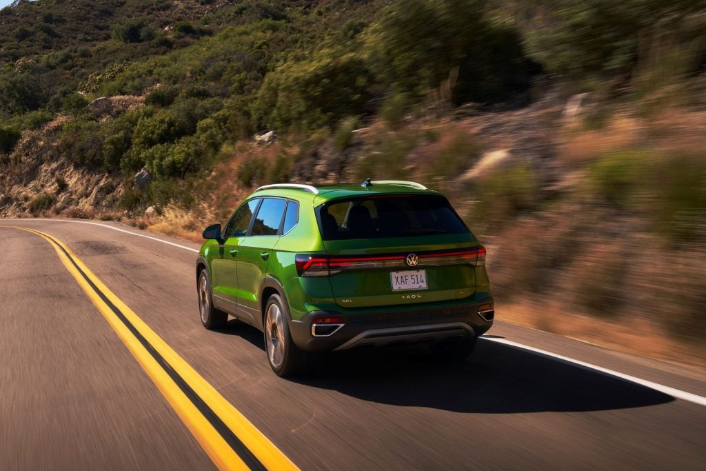 The Spring Green 2026 Volkswagen Taos Driving On Winding Roads Past Green Hills