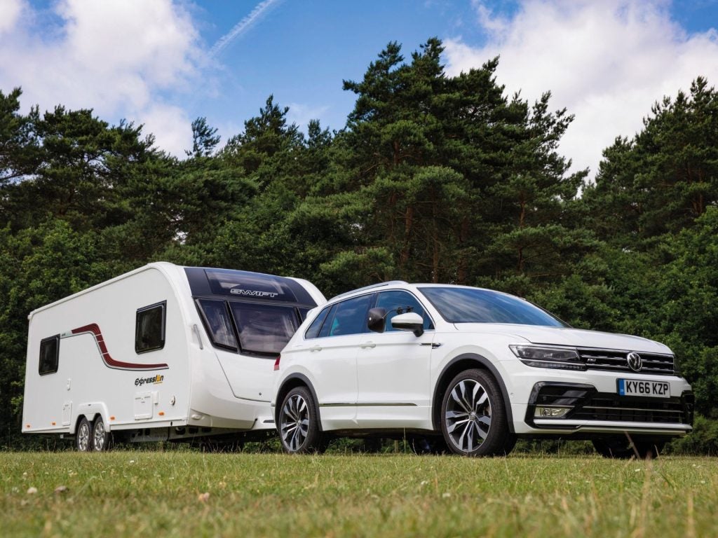 The Powerful Volkswagen Tiguan Towing A Long, White Trailer With Ease