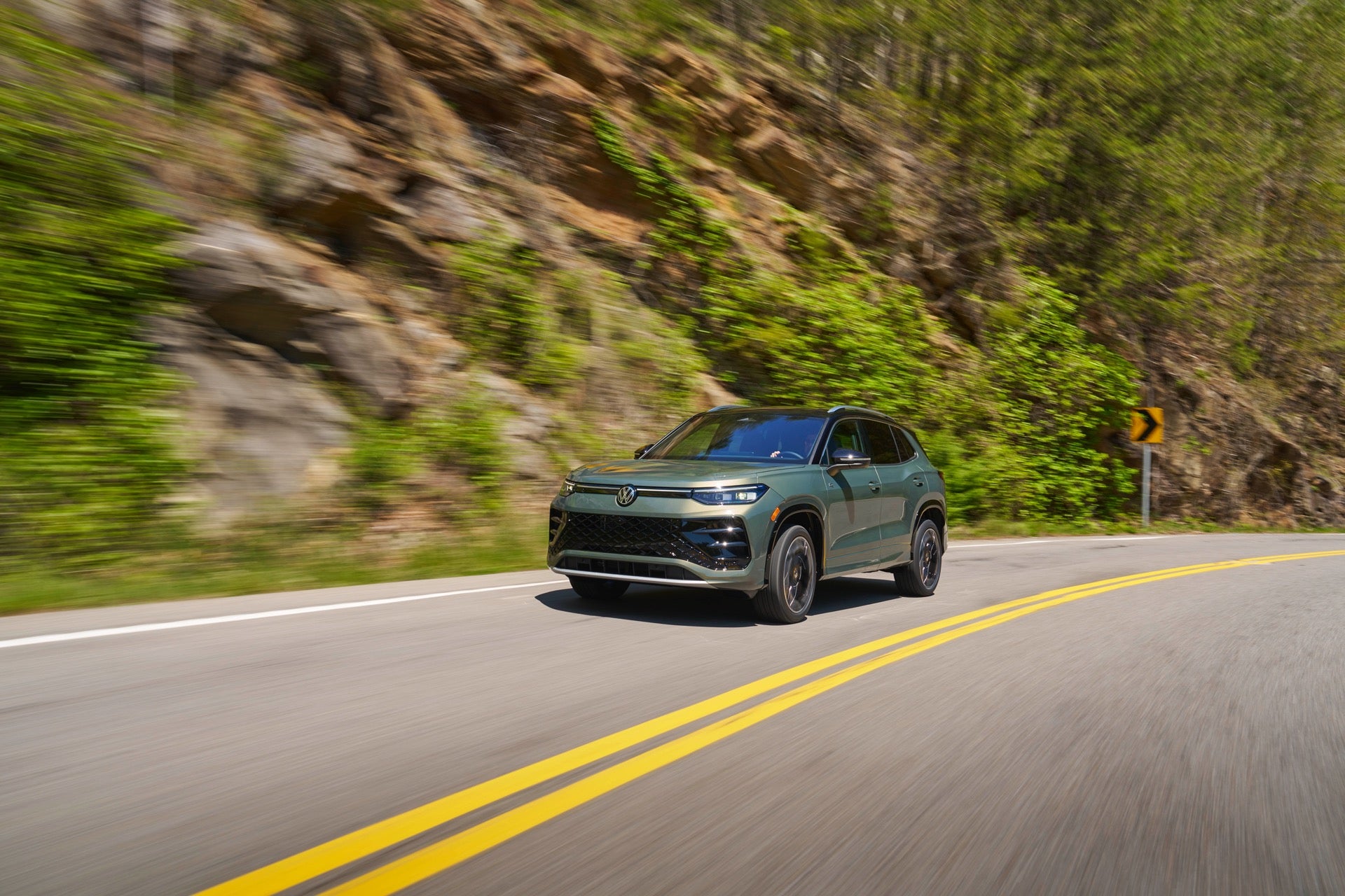 An Avocado Green 2026 Volkswagen Tiguan, Driving On The Highway Towards The Road Trip's Next Destination