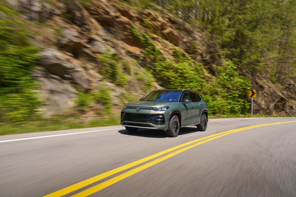 An Avocado Green 2026 Volkswagen Tiguan, Driving On The Highway Towards The Road Trip's Next Destination