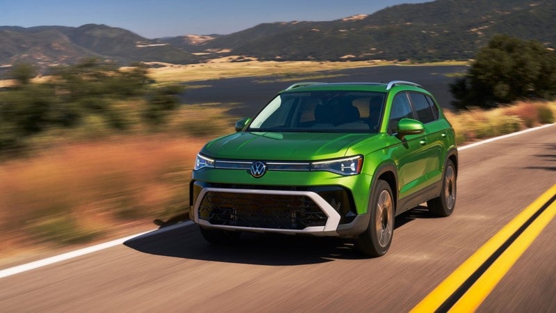 New Volkswagen Taos Driving down a desert highway