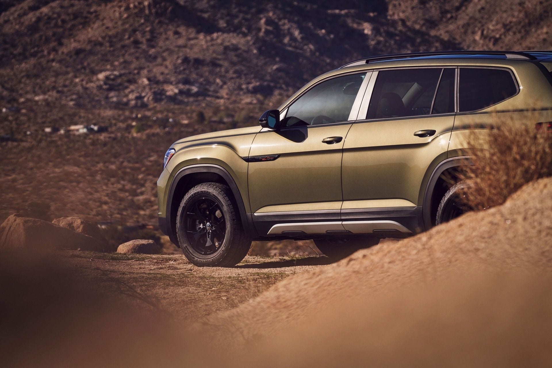The Golden Volkswagen Atlas Driving Through Hot, Rocky Area