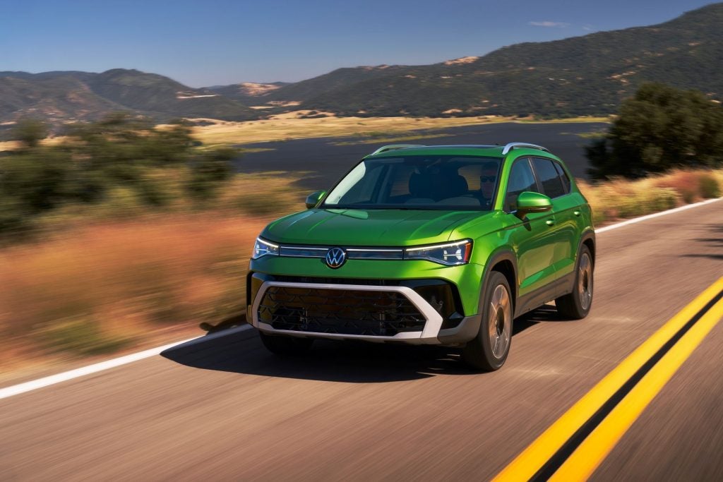 A Bright Green 2026 Volkswagen Taos Driving With An Efficient Fuel Economy