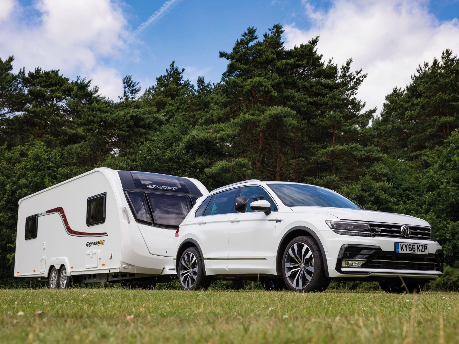 The Powerful Volkswagen Tiguan Towing A Long, White Trailer With Ease