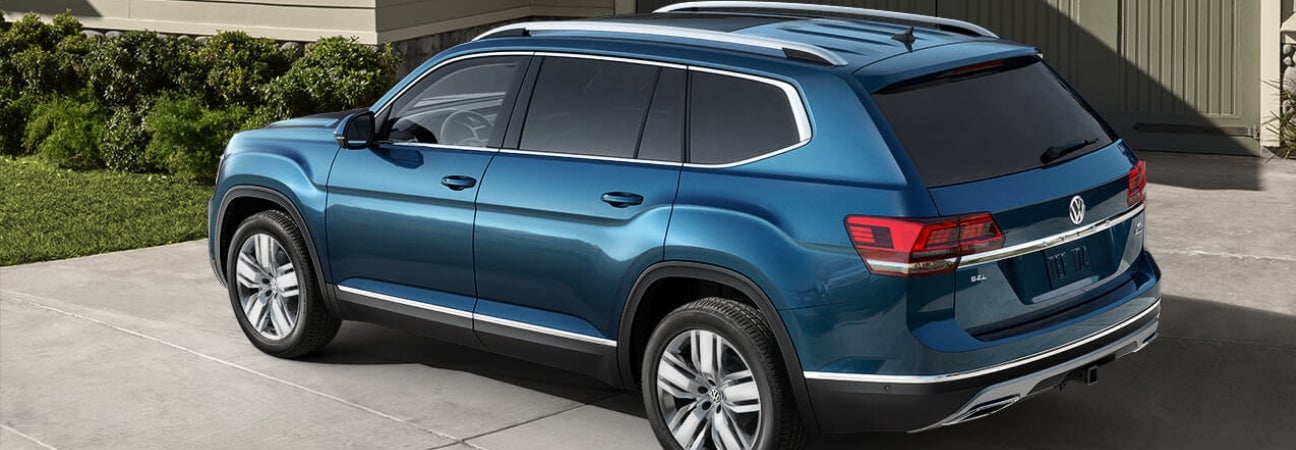 2019 Volkswagen Atlas in blue parked in the driveway of a home.