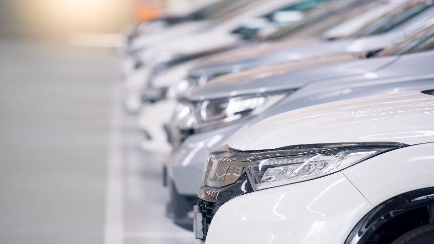 A row of vehicles on a dealership lot.