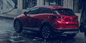 Red 2019 Mazda CX-3 driving in the rain | Mazda Dealer | Houston, TX