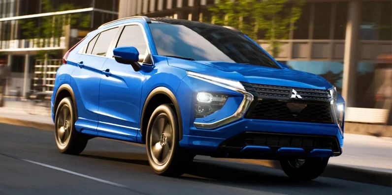 A blue Mitsubishi Eclipse Cross driving down the road.