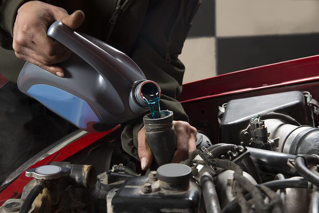 Pouring antifreeze into a tank (1)