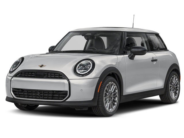 A silver MINI Cooper parked, showing its compact design and round headlights.