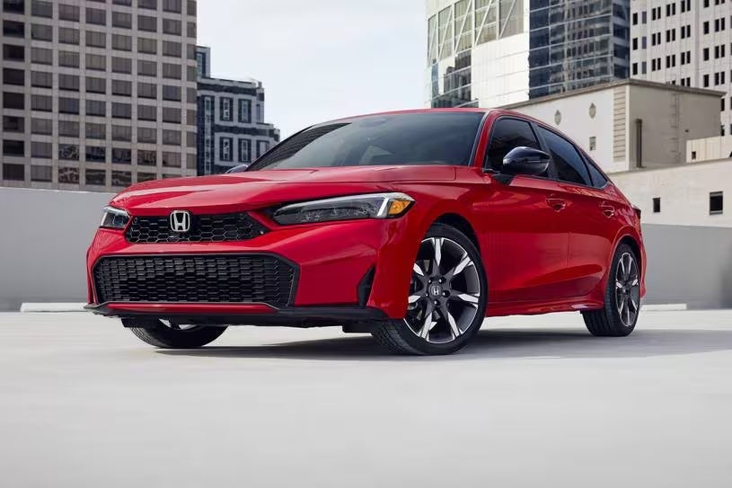 2025 Honda Civic Sedan in red on the top floor of a city parking garage