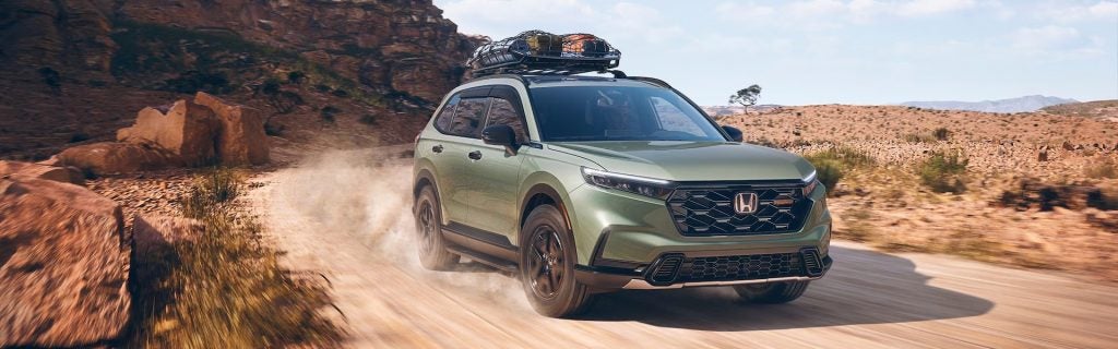 2026 Honda CR-V driving on a rugged desert trail with roof cargo