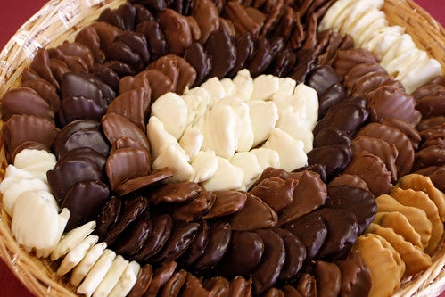 Chocolate candies of various colors arranged in wicker basket