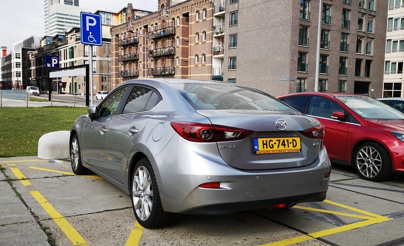 Silver Mazda3 sedan in parking spot