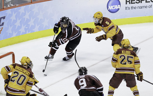 A hockey player making a goal in a game