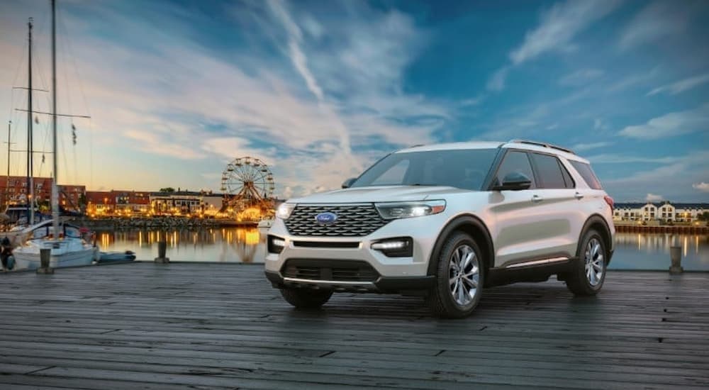 A white 2024 Ford Explorer parked near a carnival.