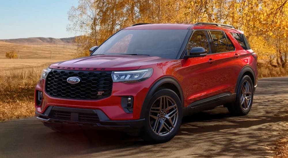 A red 2026 Ford Explorer ST parked on a backroad.