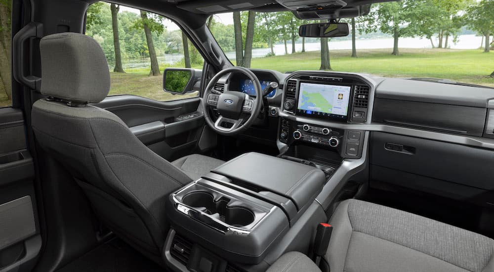 The grey interior of a 2025 Ford F-150 from the rear seats.