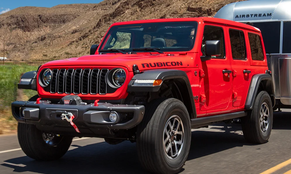 The 2025 Jeep Wrangler driving on a rocky path.