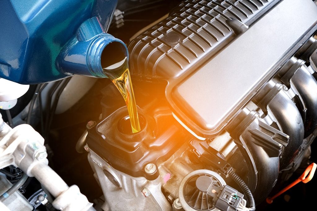Refueling and pouring oil quality into the engine motor car Transmission and Maintenance Gear .Energy fuel concept.