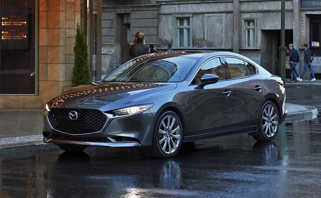 Image of a gray 2019 Mazda3 parked on the street.