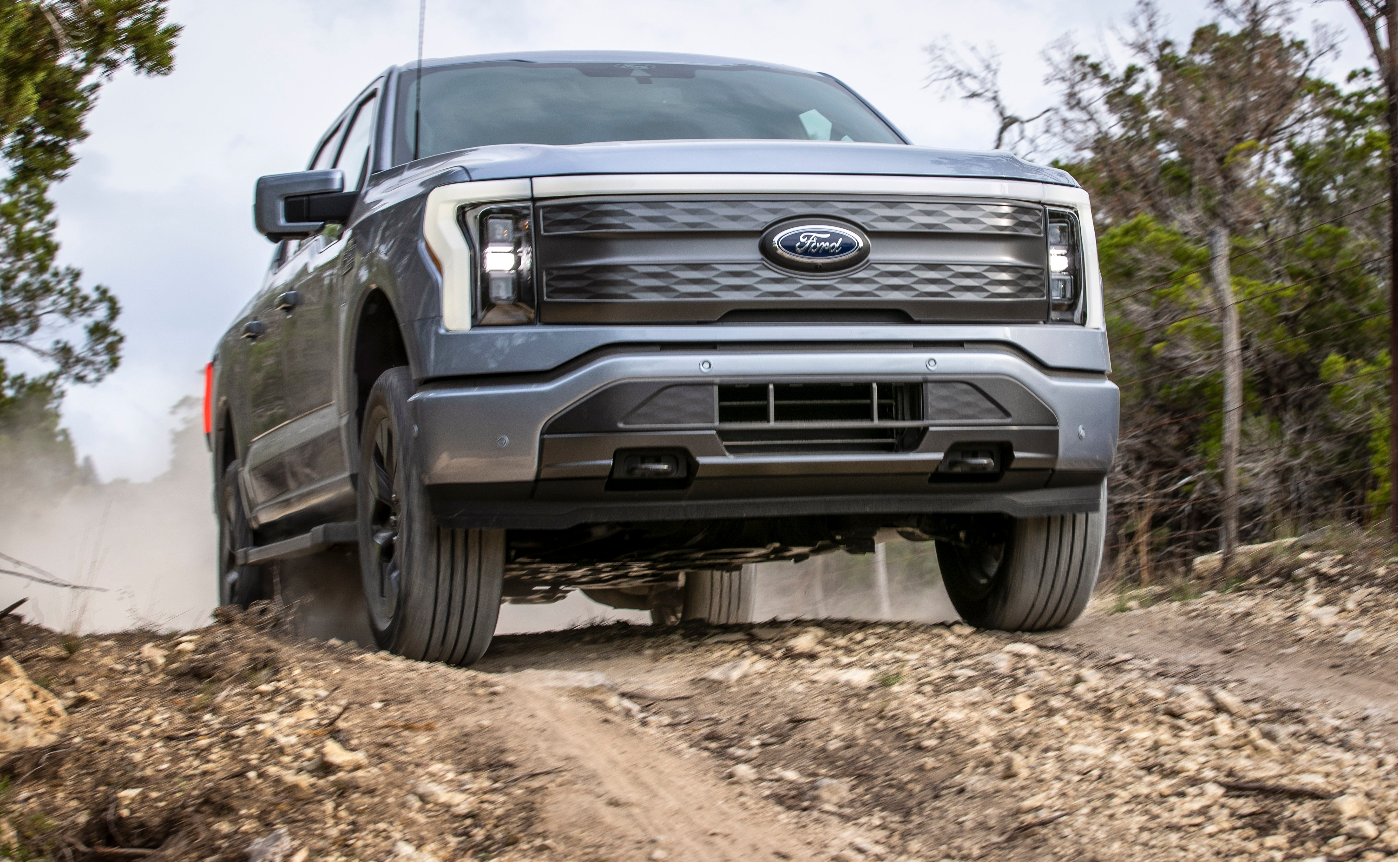 Ford F-150 Lightning Driving on a Dirt Road