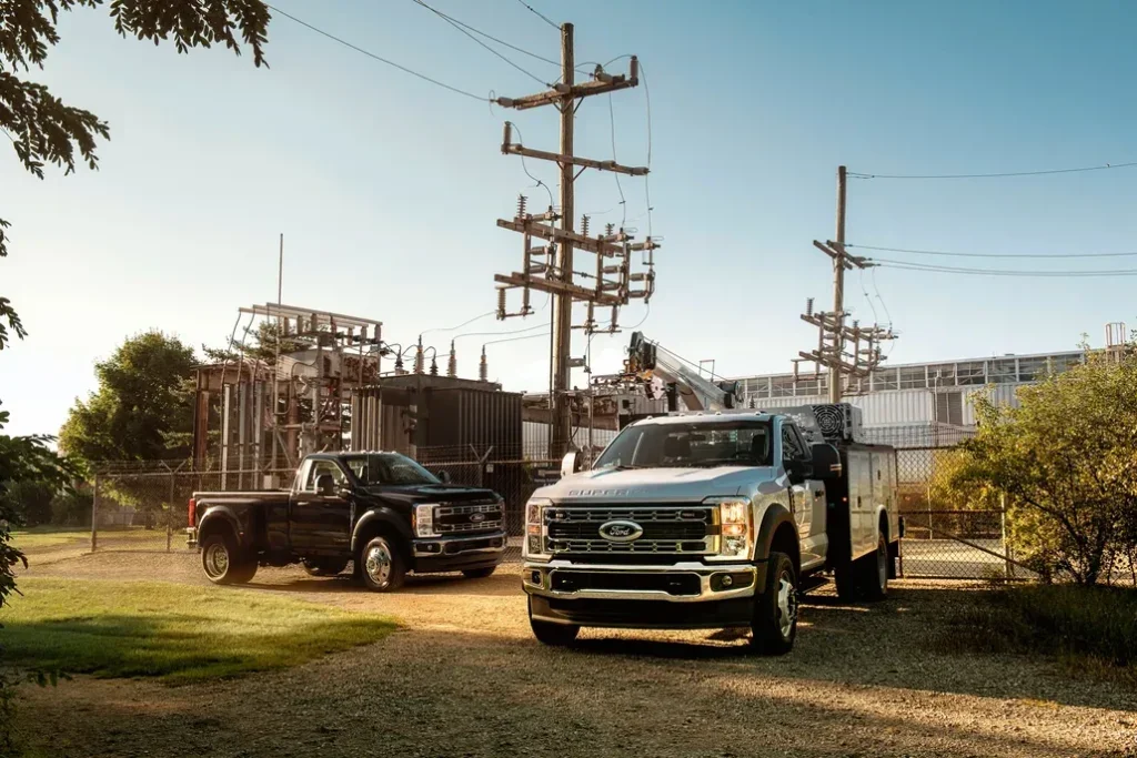 Two Ford F-550s Parked in Front of an Electrical Plant