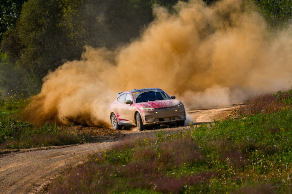 Mustang Mach-E Rally Driving on a Muddy Rally Trail Front 3/4 View