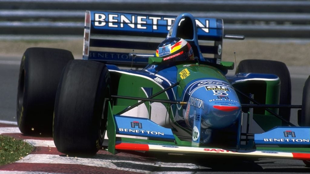 The Benetton Car coming around the curve in a formula 1 race
