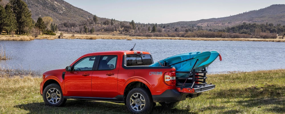 Red Ford Maverick at a lake in Northern Wisconsin | Best Ford Vehicle for camping on a budget
