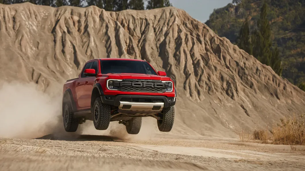 Red Ford Ranger Raptor catching some air in the desert mountains