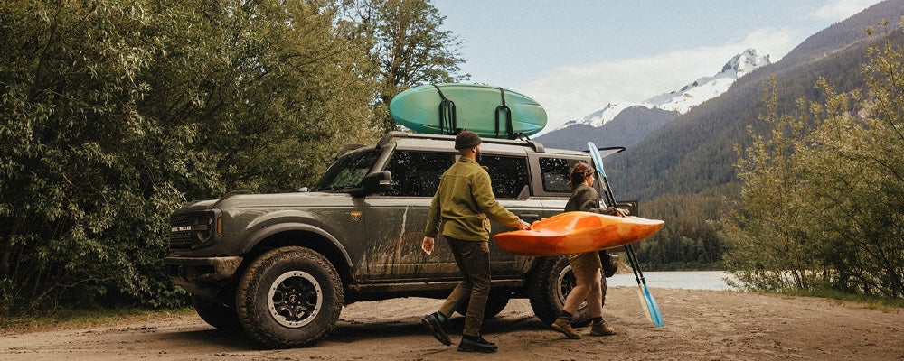 People taking their Ford Bronco by a lake in Wisconsin to go kayaking | Best Ford Vehicle for Camping
