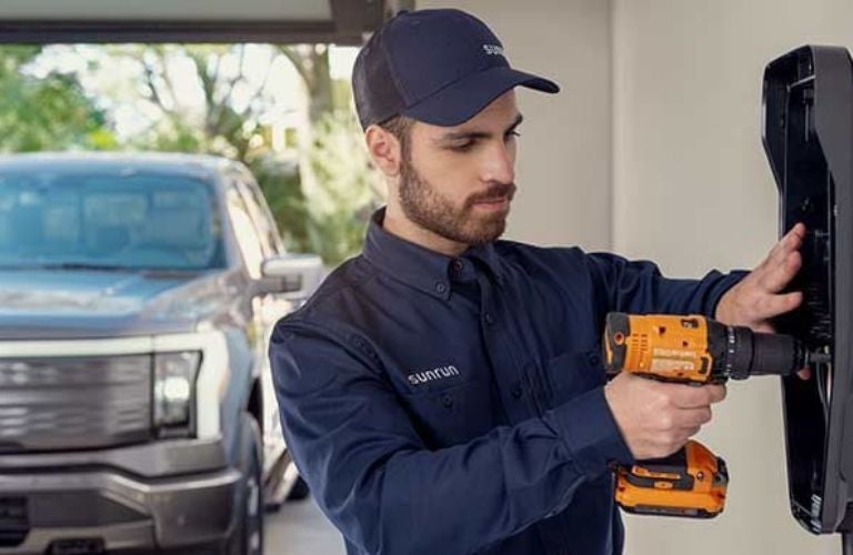 Sunrun Service Tech Installing a Ford EV Charging Station in a Garage