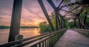 Wooden bridge for walking in a forested area. 