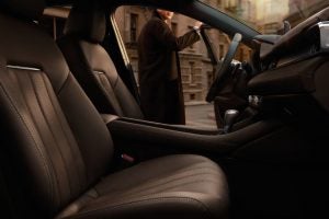 Interior view of a 2020 Mazda6 Skyactiv with a man holding the driver side door open. | Mazda dealer in Ellisville, MO.