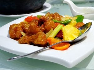 Sweet and sour pork on a white plate. 