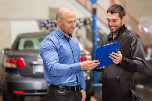 Mechanic giving service report to customer