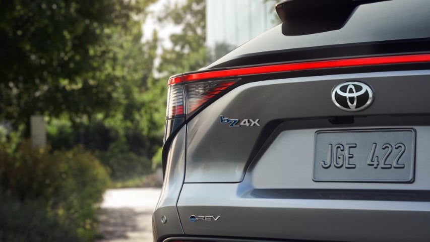 Close-up of the rear badge on a Toyota bZ4X electric SUV showing the model name and EV branding.