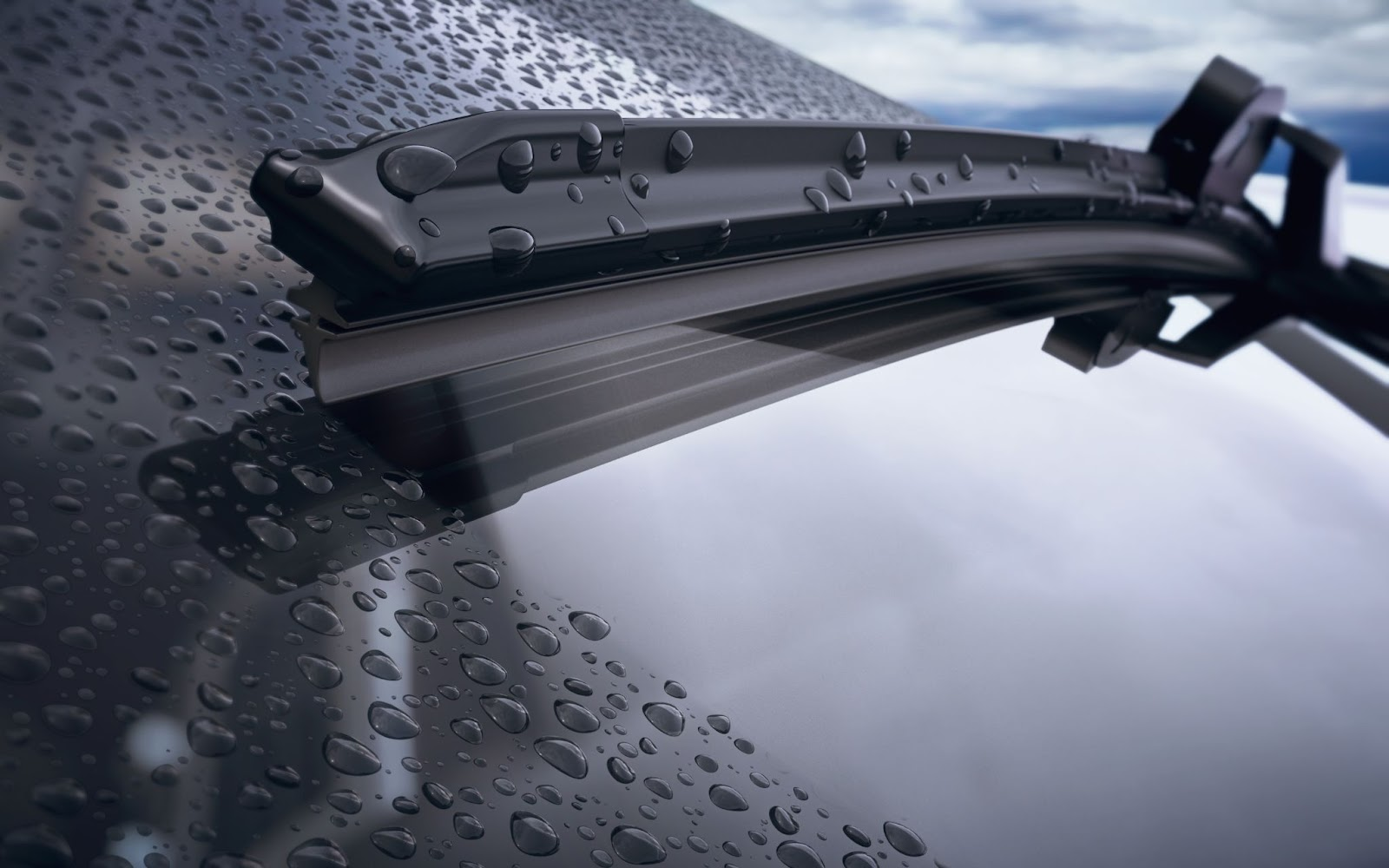 A car wiper blade cleaning the rain off a windshield
