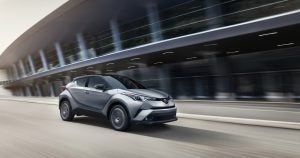 A silver 2019 Toyota CH-R driving down the freeway.