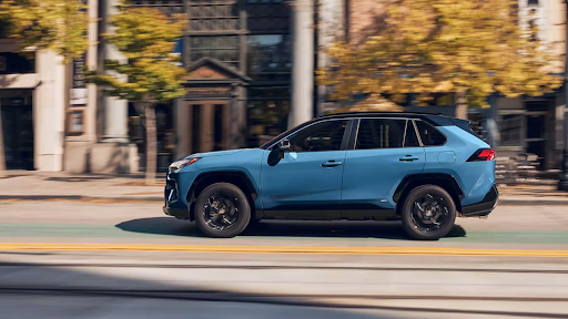 2023 Toyota RAV4 Hybrid driving on a city street