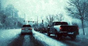 Cars stopped at a dreary winter stop-light.