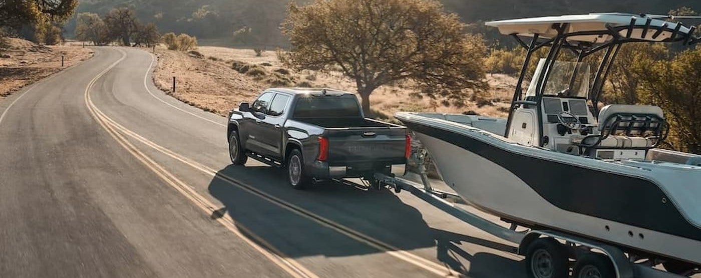 A gray 2026 Toyota Tundra towing a boat.
