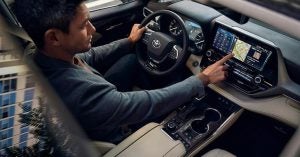 A man driving the all new 2020 Toyota Highlander.