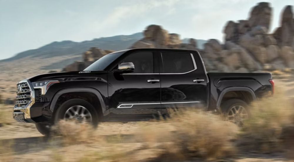 Black 2026 Toyota Tacoma 1794 Edition driving through the desert.