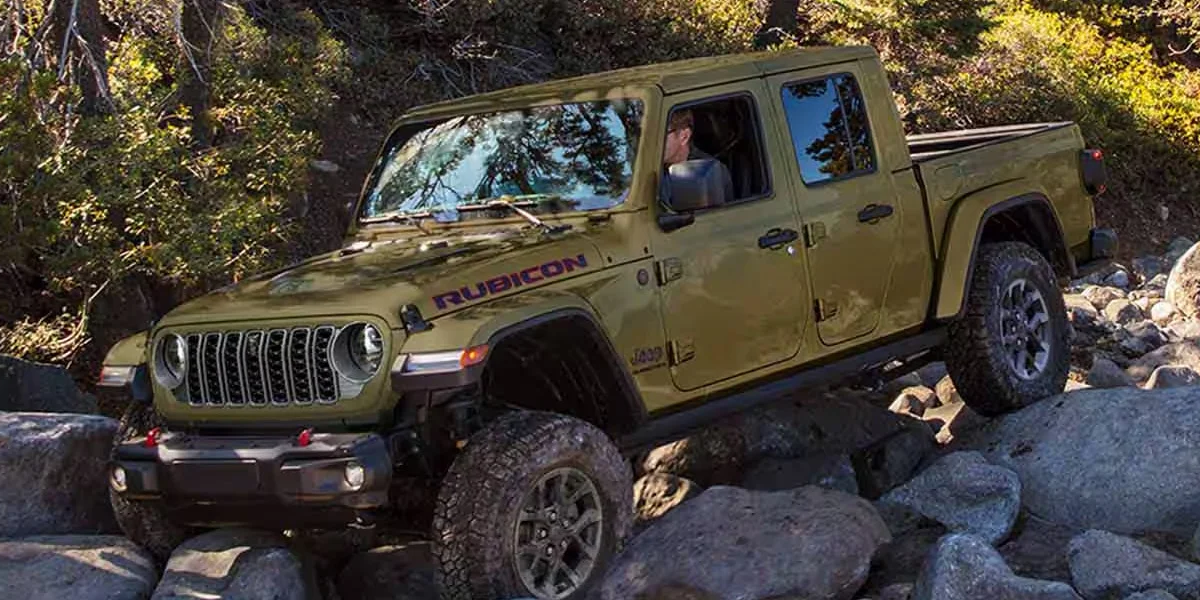The 2025 Jeep Gladiator navigating a rocky mountainous terrain