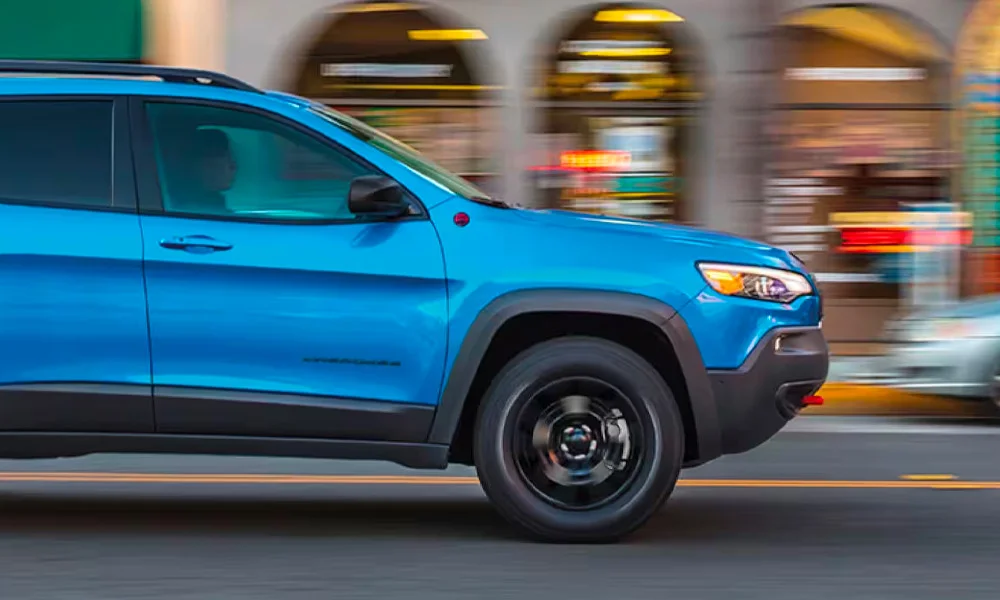 A 2023 Jeep Cherokee speeding through a city
