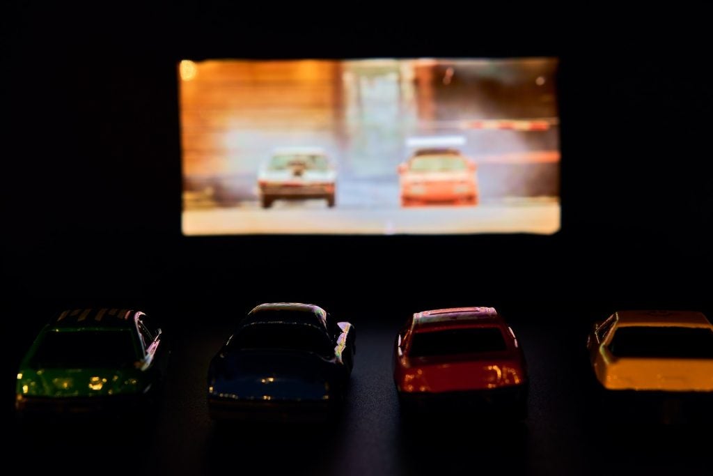 Cars parked at a drive in theater.